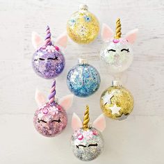 unicorn ornaments with glitter on them are arranged in a circle