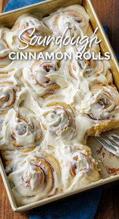 cinnamon rolls in a baking pan with a fork