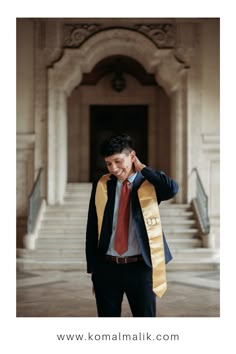 a man in a suit and tie is holding his jacket over his head with both hands