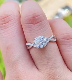 a woman's hand with a diamond ring on her finger and an engagement band