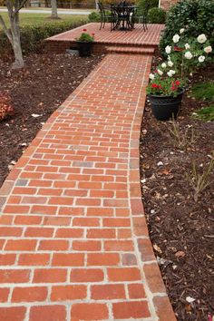 a brick walkway in front of a house