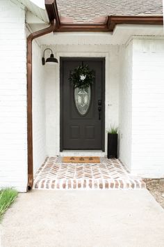 a front door with a wreath on it