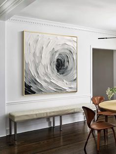 a dining room table with chairs and a large painting on the wall above it that has a bench in front of it