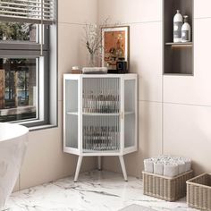 a white cabinet in a bathroom next to a window