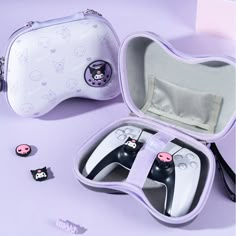 two nintendo wii game controllers in a case on a purple surface with other items around it