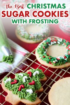 christmas cookies decorated with green and red icing on a cooling rack next to other holiday treats