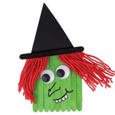 a paper doll made to look like a corn cob wearing a witch's hat