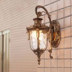 an old fashioned wall light on the side of a building