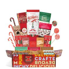 an assortment of candy and candies in a gift box with the words merry christmas on it