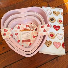 pink heart shaped bowls and plates on wooden table