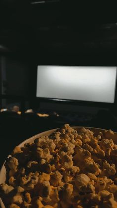 a plate full of food sitting in front of a screen with a projector behind it