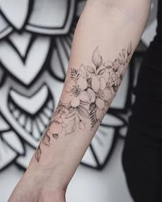 a woman's arm with flowers on it