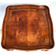 an old wooden tray sitting on top of a table