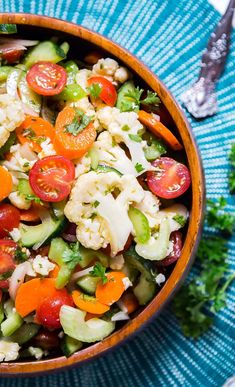 a bowl filled with vegetables on top of a blue plate