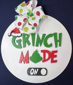 the grinch mode sign is decorated with green and red polka dots, an elf's hat, and a white bow