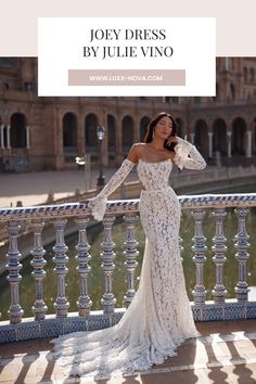 a woman in a white dress standing on a balcony with her arms around her neck