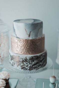 a three layer cake sitting on top of a glass plate