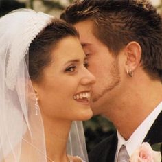 a bride and groom are smiling for the camera