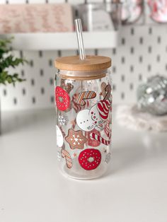 a glass jar filled with different types of cookies and doughnuts on top of a counter