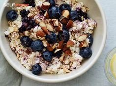 a bowl filled with oatmeal, blueberries and almonds