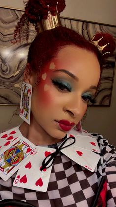 Woman with Queen of Hearts Makeup. Wearing blue eyeshadow, red blush, red hair and crowns Alice In Wonderland Costume Makeup, Queens Of Hearts Makeup, Queen Of Heart Makeup Ideas, Queen Of Hearts Makeup Look, Queen Hearts Makeup, Queen If Hearts Makeup, Costume Women Diy