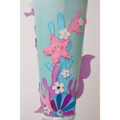 a blue vase with pink and purple decorations on it