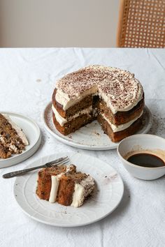 there is a cake with white frosting on it and two slices missing from the cake