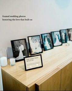 a wooden table topped with pictures and candles