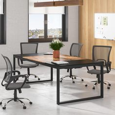 a table with chairs and a potted plant on it in front of a window