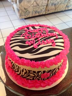 a zebra print birthday cake with pink frosting