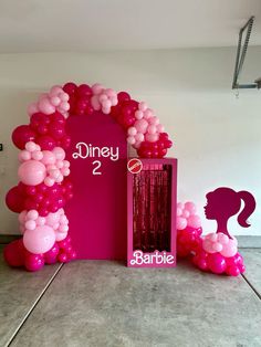 balloon arch with pink and white balloons in front of it