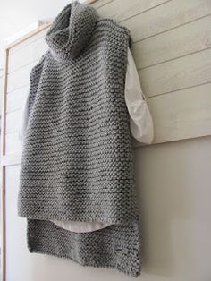 a knitted sweater hanging on the wall