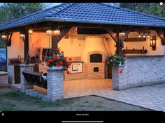 an outdoor kitchen is lit up at night