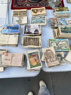 a table topped with lots of different types of cards and papers on top of it