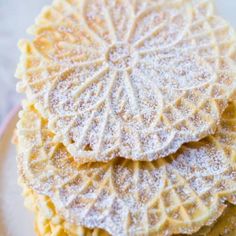 three cookies are stacked on top of each other with powdered sugar covering the edges