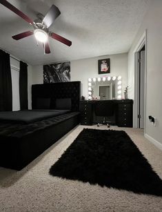 a bedroom with a black bed, mirror and lights on the ceiling is decorated in modern style