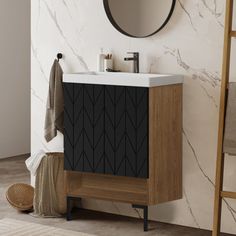 a bathroom vanity with a mirror above it and a towel on the rack next to it