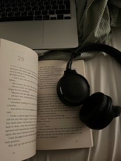 an open book with headphones on top of it