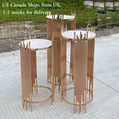 three round tables sitting on top of a sidewalk