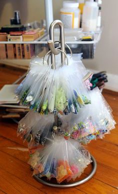 a bunch of bags that are on top of a metal stand in the middle of a wooden floor