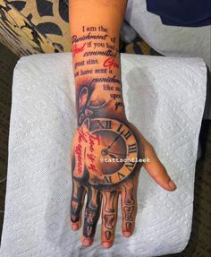 a person's hand with a tattoo on it that says i am the clock