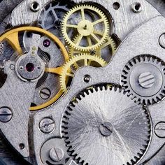 the inside workings of an old watch with gears