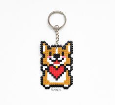 a keychain with an image of a cat on it's face in the shape of a heart