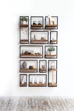 a wall shelf filled with lots of different types of items on top of wooden shelves