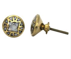 a pair of gold tone metal buttons with an intricate design on the front and back