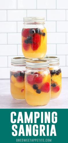 four mason jars filled with fruit sitting on top of a counter