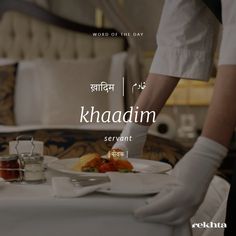 a person in white gloves standing over a table with food on it and the words khadadm written in arabic