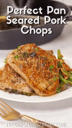 the perfect pan seared pork chops on a white plate with asparagus