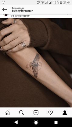 a person with a bird tattoo on their arm