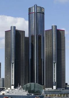 a large boat in the water near some tall buildings